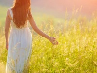 Bride Enjoying Nature. Free Happy Woman. Lit evening sun. Freedom concept.