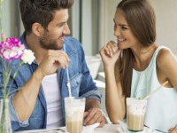 Smiling couple in cafe enjoying the time spending with each other