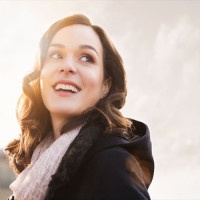 Closeup of smiling thinking woman looking away outdoor