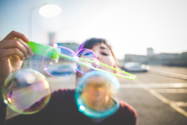 young beautiful hipster woman bubble blower