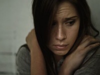 A young woman looking anxious and fearful