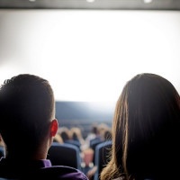 Group of people at the cinema watching a movie