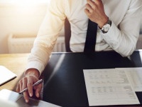 Business man working at office with laptop and documents on his desk, consultant lawyer concept