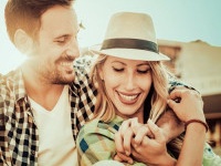 Happy couple in love having fun outdoors and smiling.