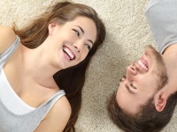 Happy couple lying and laughing