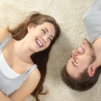 Happy couple lying and laughing