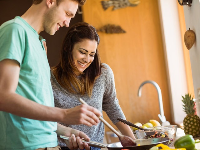 Cute couple preparing food together