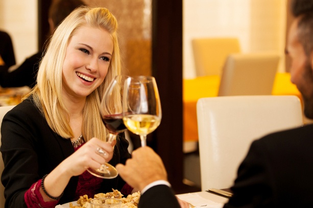 Young couple eat sea food dinner at restaurant and drink wine