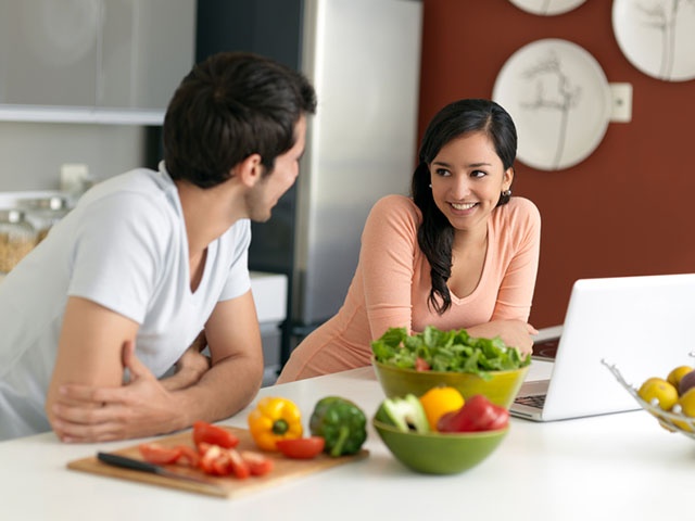 Latin couple hanging out in the kitchen