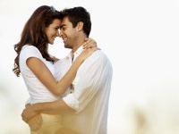 Loving young couple embracing in a corn field together - copyspace