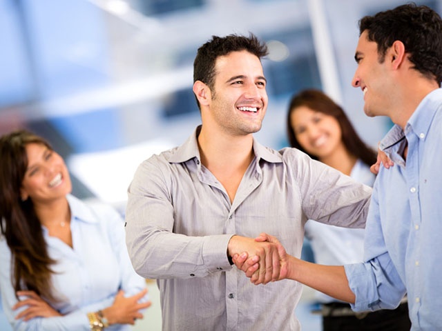 Coworkers shaking hands and getting along