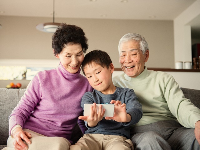 Grandson taking a family photo with smartphone