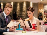 young happy couple in restaurant reading menu