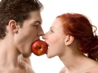 Couple biting an apple, isolated on white