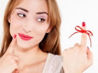 woman red bow on finger, isolated on white background