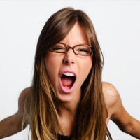 Angry woman screaming on white background
