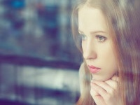 alone thoughtful sadness girl is sad at the window