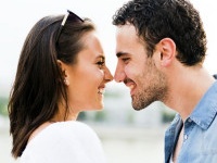 Young beautiful couple rubbing noses as a sign of love and about to kiss each other