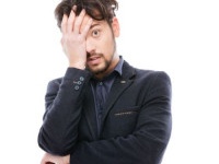 Sad businessman standing isolated on a white background