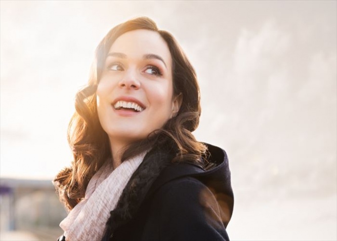 Closeup of smiling thinking woman looking away outdoor