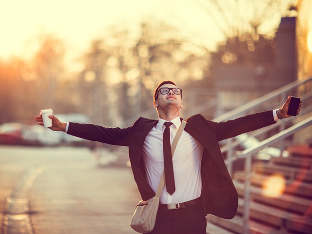 Businessman smiling with arms outstretched