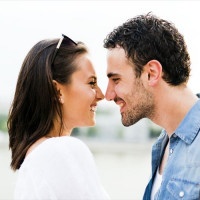 Young beautiful couple rubbing noses as a sign of love and about to kiss each other