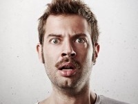 Portrait of a surprised young man with mustache