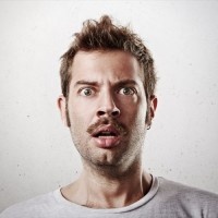 Portrait of a surprised young man with mustache