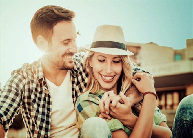 Happy couple in love having fun outdoors and smiling.