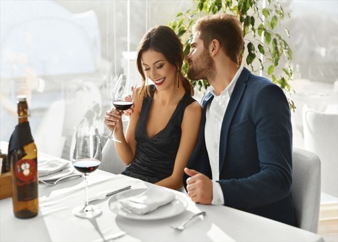 Couple In Love. Happy Romantic Smiling Elegant People Having Dinner, Drinking Wine, Celebrating Holiday, Anniversary Or Valentine's Day In Gourmet Restaurant. Romance, Relationships Concept.