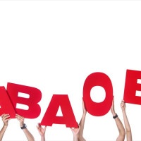 Group of people holding large blood group letters (education or medicine concept)