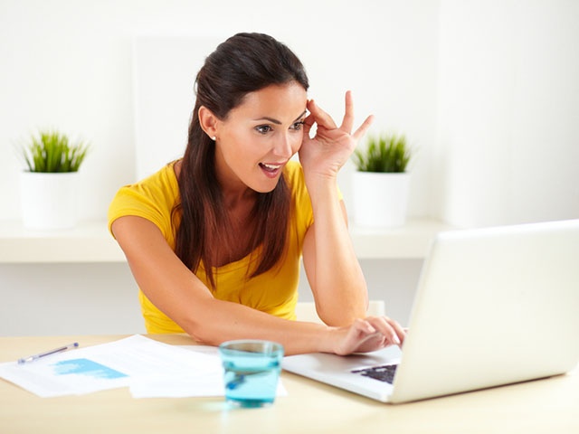 Pretty surprised businesswoman sitting in office