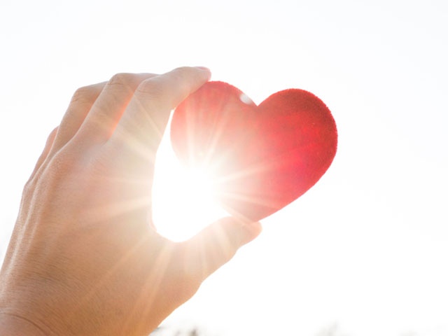 Holding heart under the sun