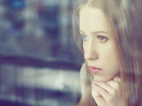 alone thoughtful sadness girl is sad at the window